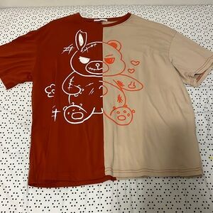 Half tan half maroon brownish bear graphic tee.